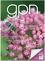 The cover of GPN magazine with a pink flower with a bee on it.
